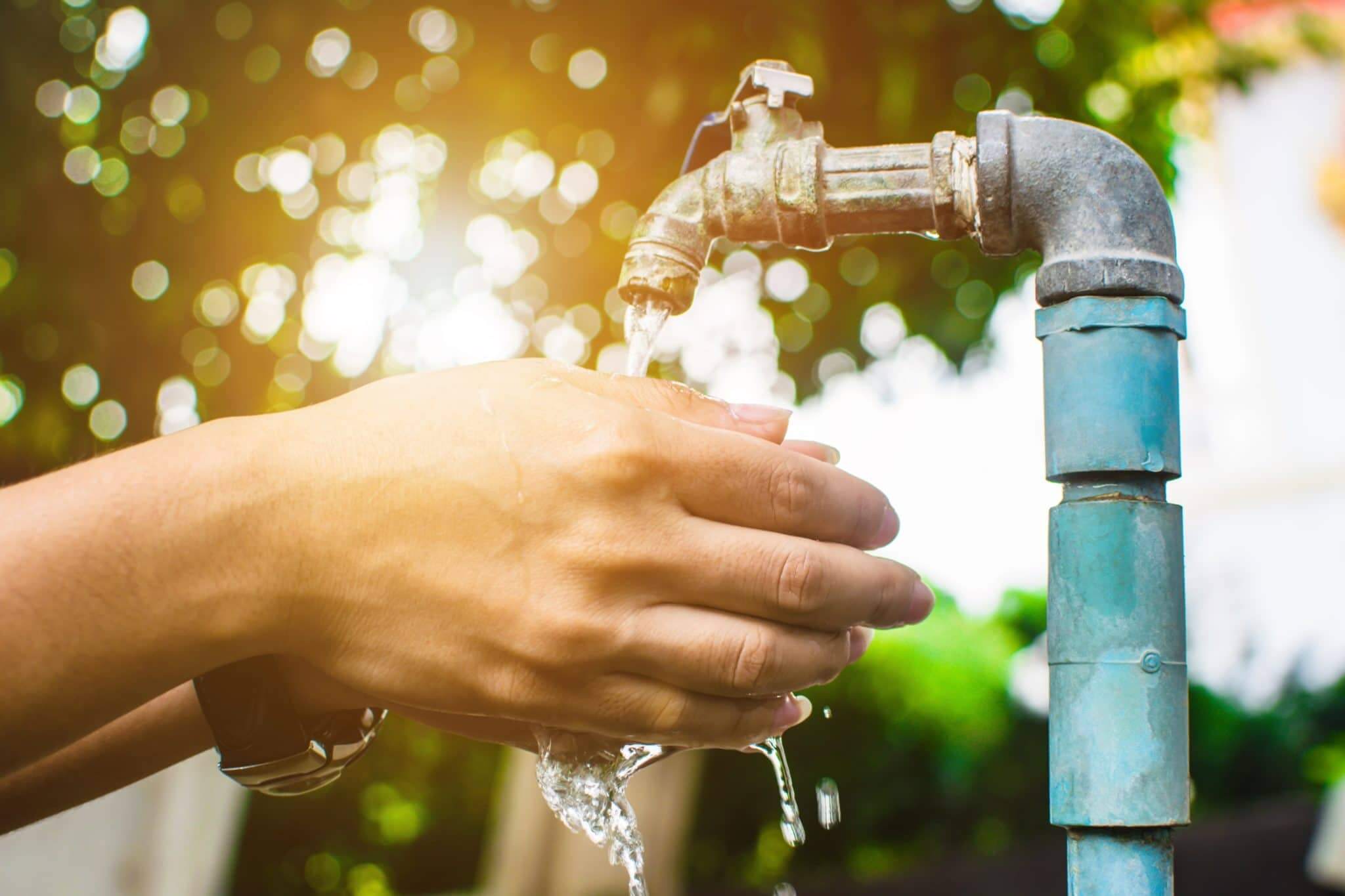 woman washing hands under an RV water pressure regulator