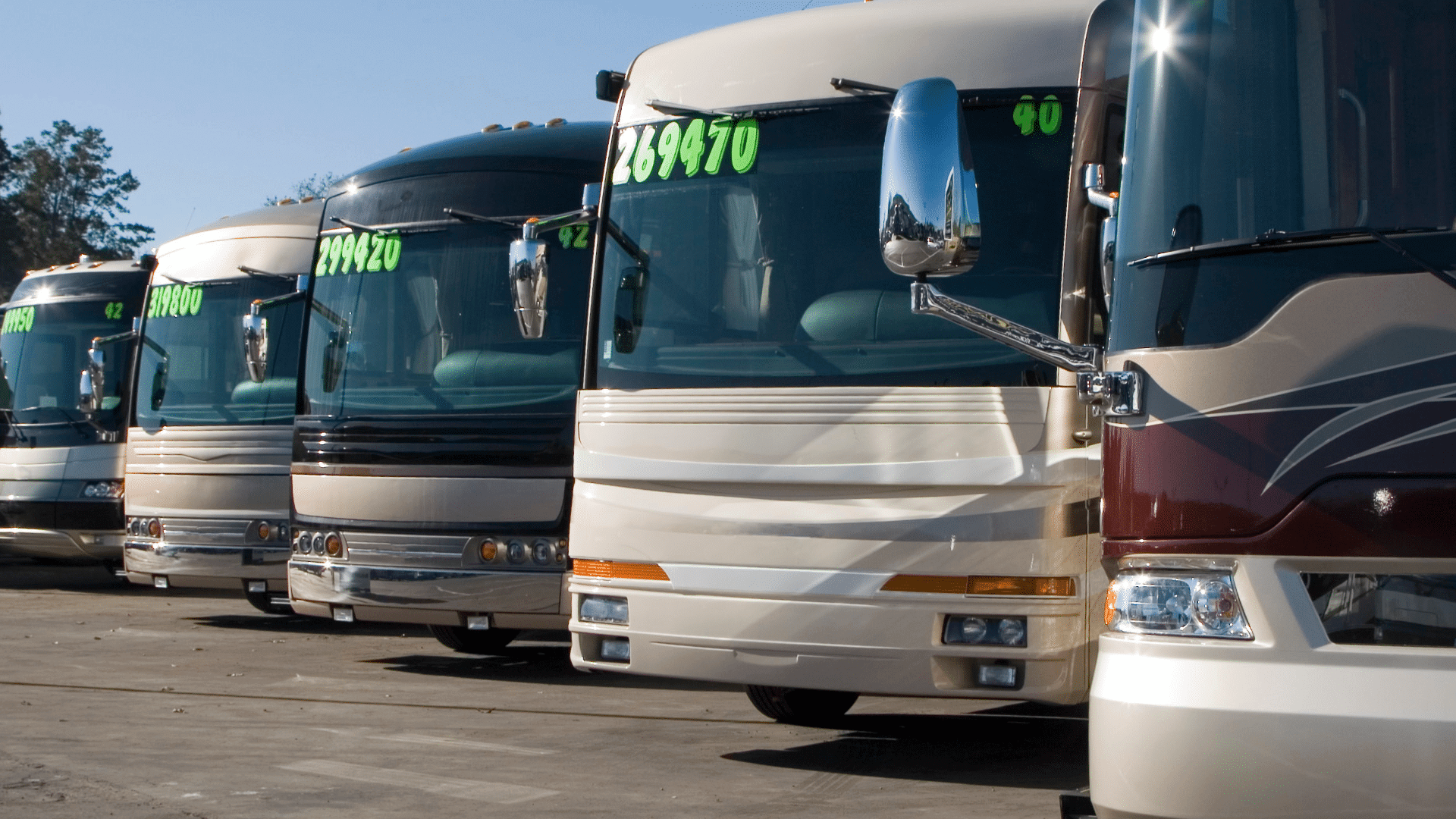 RV prices displayed on window of motorhomes on RV lot