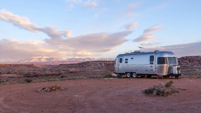 A silver airstream is the ultimate off-grid RV with these top 5 upgrades! It can stay camped out in the desert for much longer than most RVs.