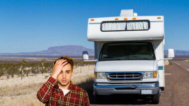 A man stands in front of his RV and regrets investing money into an FMCA membership.
