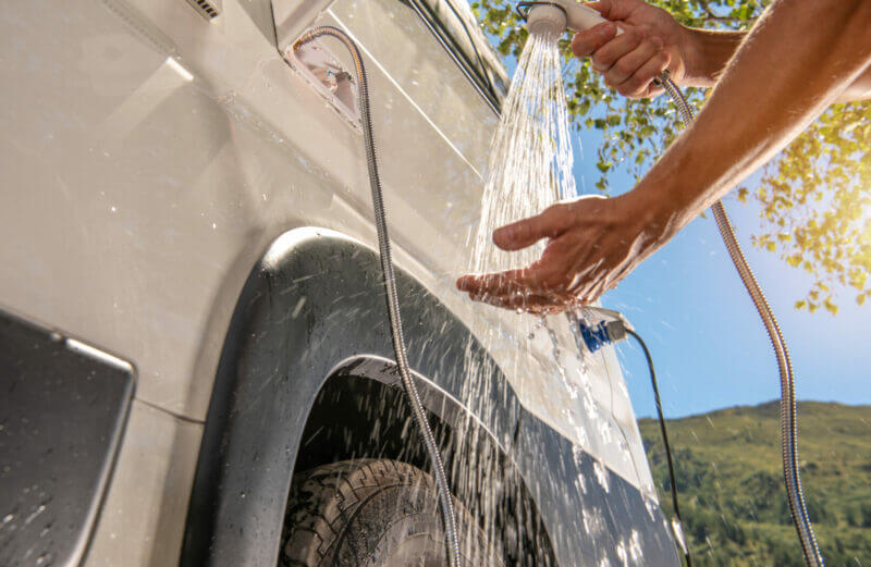 Man testing his RV water heater temperature.
