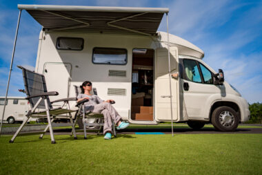 Woman resting near her class B motorhome.