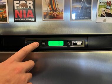 A hand turns off the rv 3 way fridge so that they are safe while driving the RV.