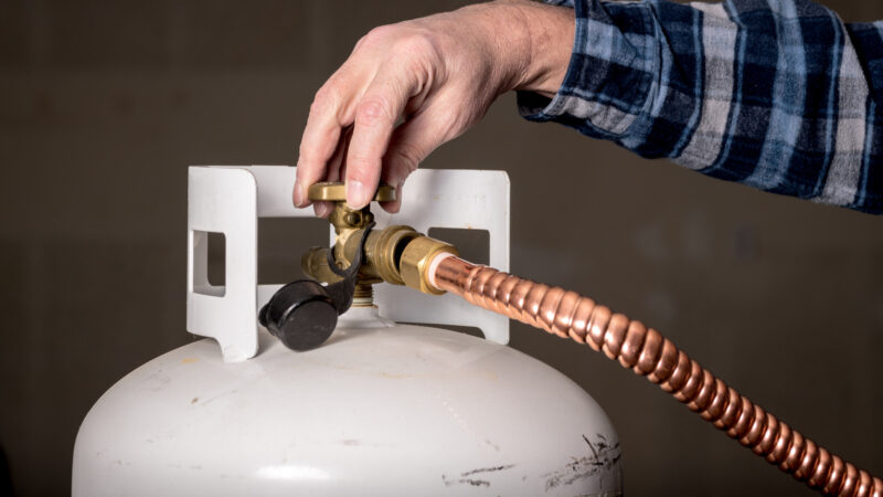 Hand screwing attachment onto external propane tank