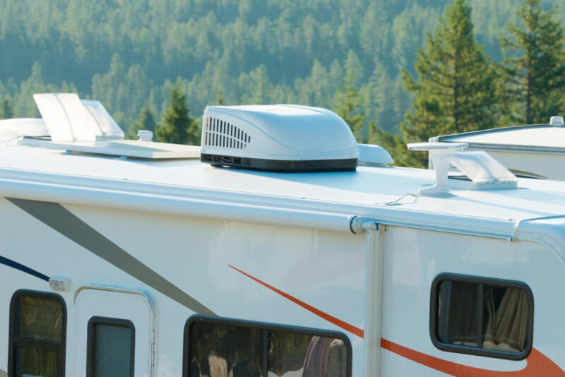 A rooftop RV air conditioner on a motorhome out in the wilderness.