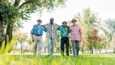 Senior people having fun at the park in fun summer shirts.