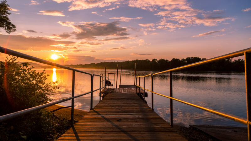 A sunset on a river in Wisconsin where you can camp in a beautiful state park.