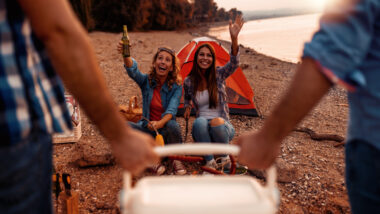 A group of friends about to enjoy cold drinks using a portable ice makers from their RV