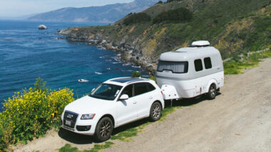 An Airstream Nest being towed by an SUV