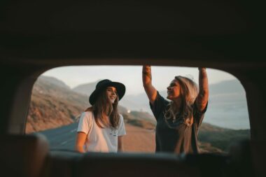 Two friends pulling over to stop at their next roadside america app location