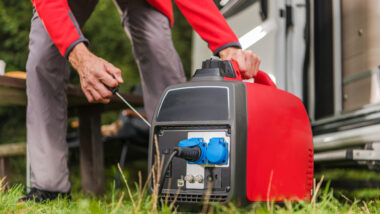 A person setting up their RV generator for their air conditioner