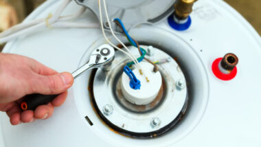 A person troubleshooting their RV water heater