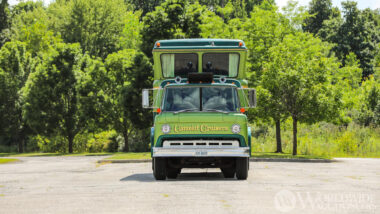 A green camelot cruiser parked outside