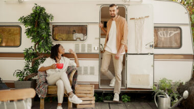 A couple talking by their RV after decorating their campsite