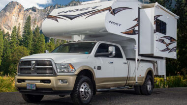 A Tahoe Longbed Host Campers parked outside