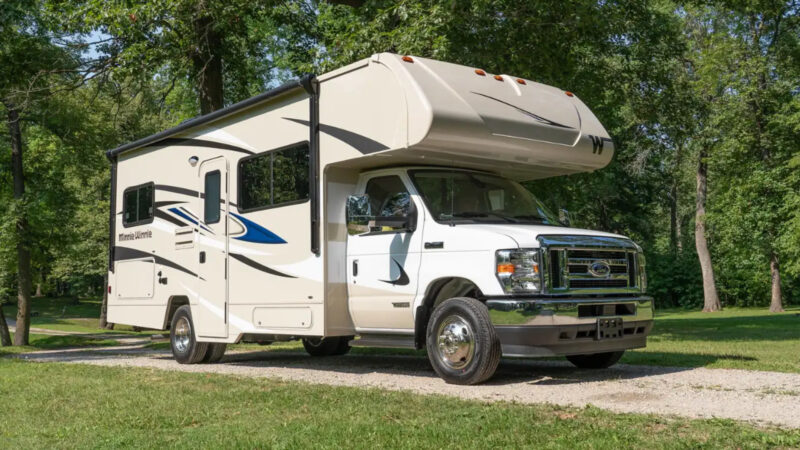 A Winnebago Minnie parked outside