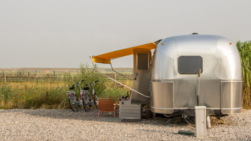 A camper with an aluminum siding outside