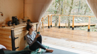 A woman sitting inside her clamping tent