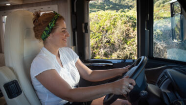 A woman driving her RV without a seatbelt