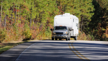 A truck towing an RV with a roadmaster tow bar