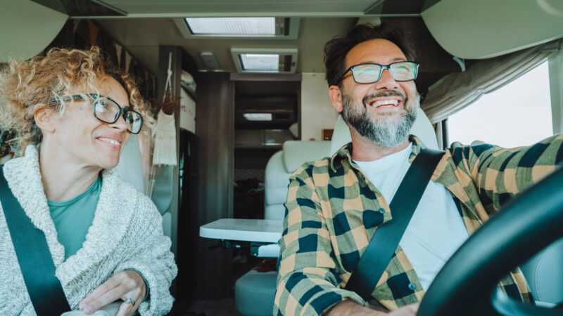 A couple driving an RV