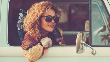 A woman sitting in her RV on her solo RV trip
