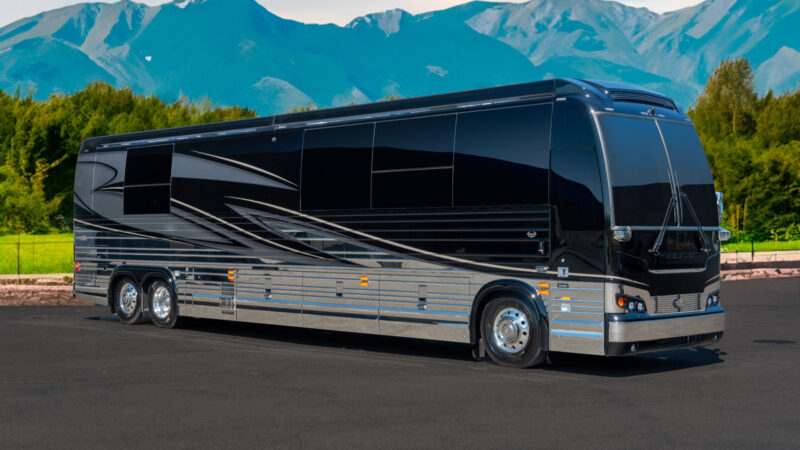 A marathon coach parked outside by the mountains