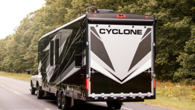 A heartland Cyclone being towed by a truck on the highway