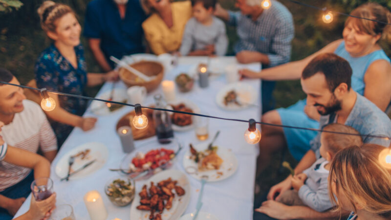A family eating thanksgiving dinner at an RV park.