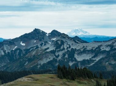 Mount Rainier with a blue cloudy sky in the background.