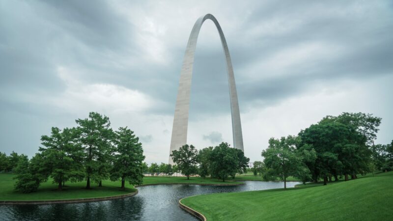 Gateway Arch National Park with a creek flowing in the foreground.