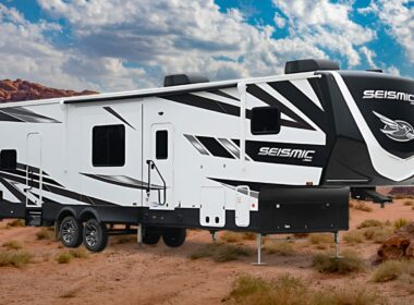 Jayco Seismic Toy Hauler RV with a desert landscape in the back.