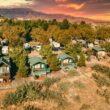 An aerial view displaying the location of Verde Valley against a setting sun, blazing the sky in orange and pink hues.