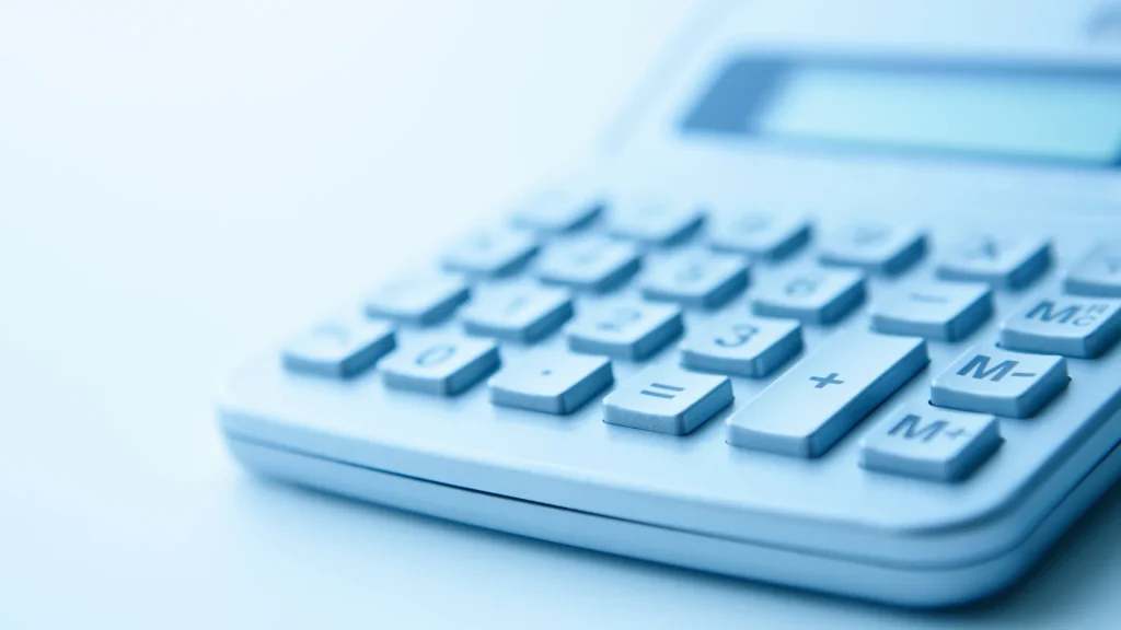 A blue calculator close up against a blue background.