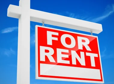 A blue sky with a red For Rent sign in the center.