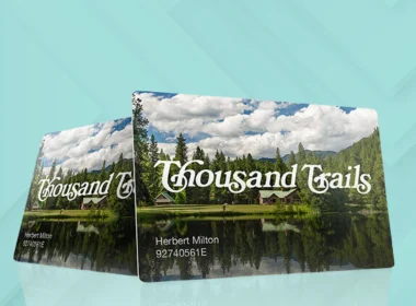 Two Thousand Trails membership cards side by side against a teal blue background.