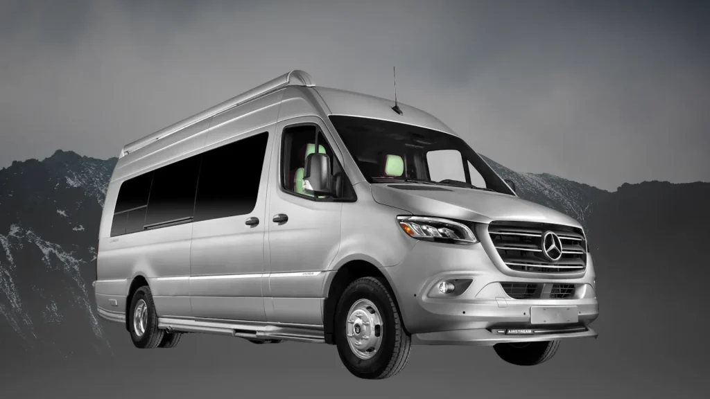 The Airstream Interstate 24GT in a silver grey sitting against a black and grey mountain backdrop. 