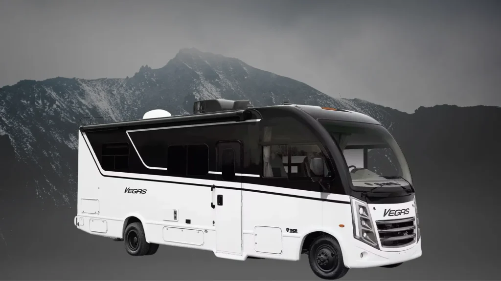 The Thor Vegas 24.1 Class A motorhome in black and white sitting against a black and grey mountain backdrop. 