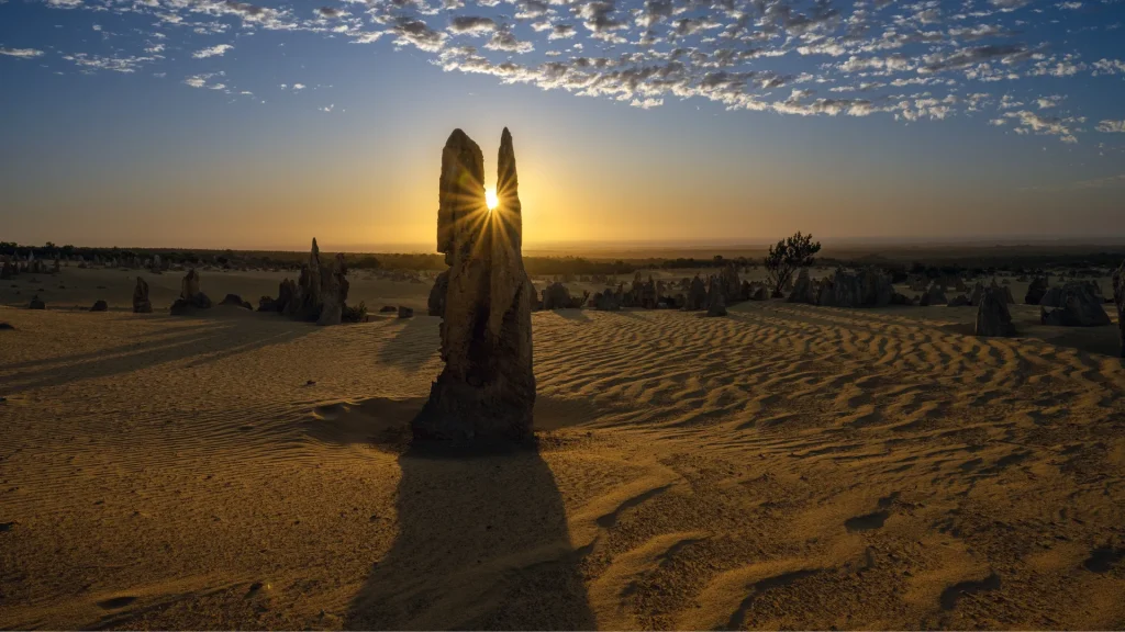 The sun rising through the crevice of one of the pinnacles in the Trona Pinnacle park.