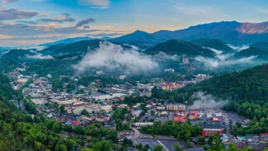 An aerial view of the city Gatlinburg as we also view the Smoky Mountains.
