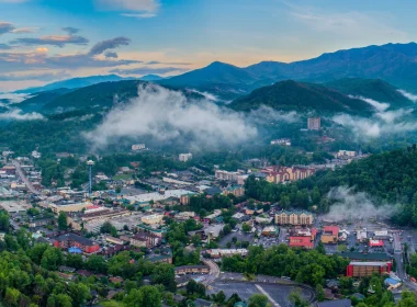 An aerial view of the city Gatlinburg as we also view the Smoky Mountains.