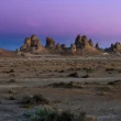 The Trona Pinnacles landscape at dusk with a blue and purple sky.