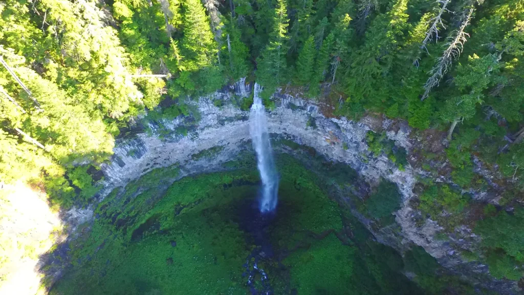 An aerial photo of the Watson Falls in Oregon displaying the height in which the water falls in this densely forested outdoor wonder.