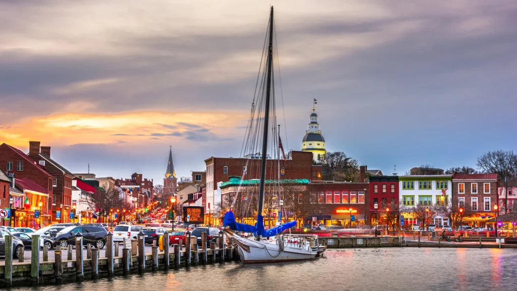 A photo at dusk with a cloudy sky of a harbor in Annapolis, Maryland. 