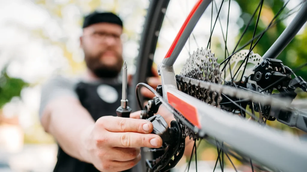 A person out of focus working on a bicycle.
