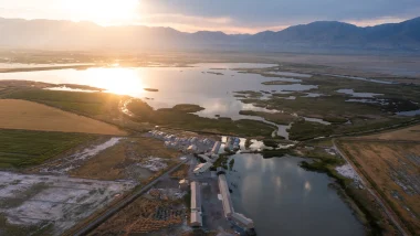 An aerial of Corrine, UT, as the sun sets over the town.