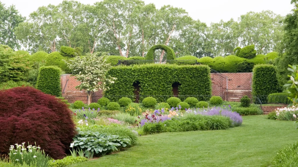 The Iris Garden at Ladew Topiary Gardens in Harford, MD, near Kilgore Falls. The garden is green and well manicured on this grey day. 
