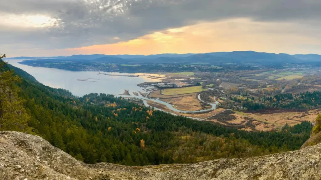 Mt Tzouhalem, Cowichan Bay, Vancouver Island, BC, Canada during a sunset as the sun peaks through the clouds. 