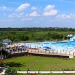 An aerial of a portion of the Buccaneer State Park. In it is a portion of the water park, bright blue sky, and green grass.