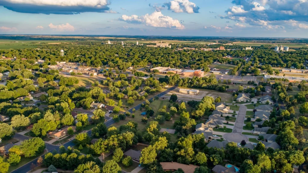 An aerial photo of Abilene, KS, as the sun shines its golden light down onto it.